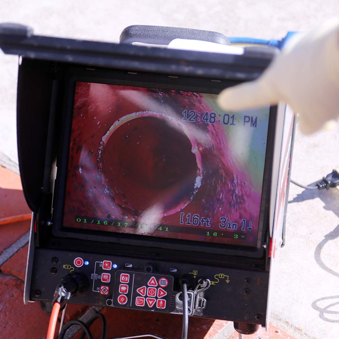 A man using a pipe snake with a camera