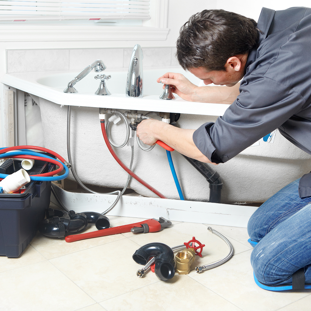 plumber working on plumbing