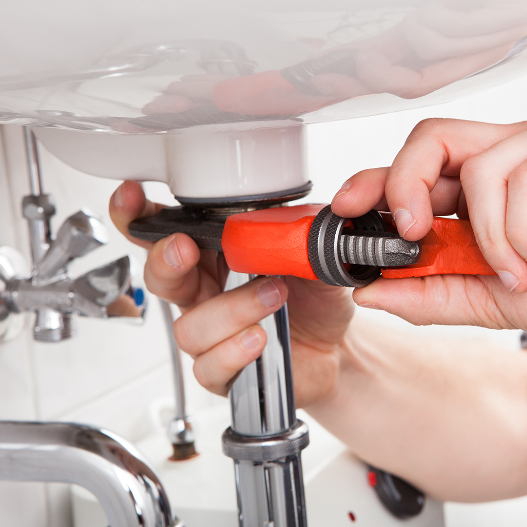 plumber working on plumbing