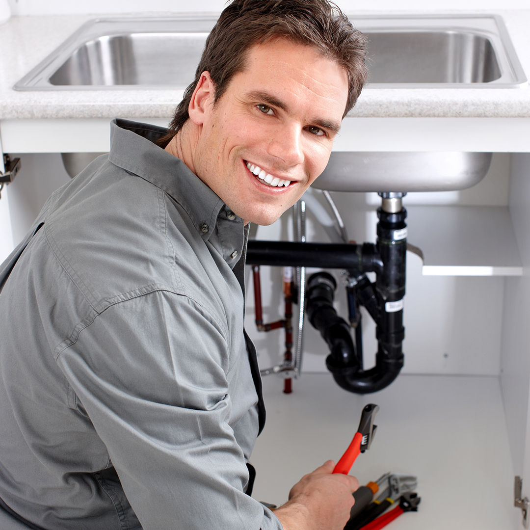 plumber working on plumbing