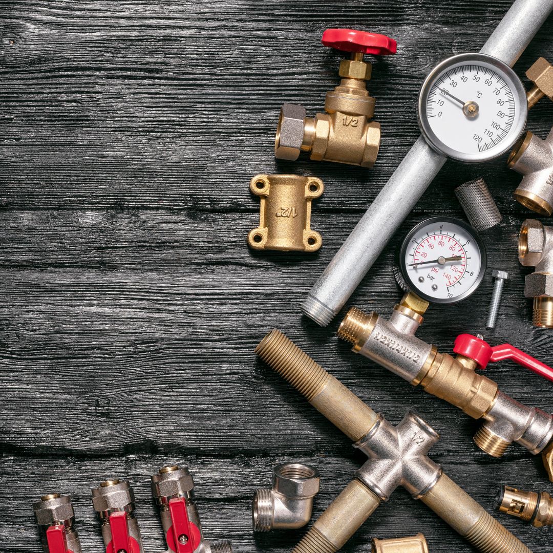 plumbing tools on wood background