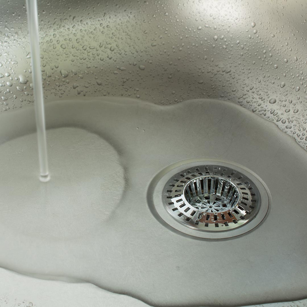 water running down kitchen sink drain