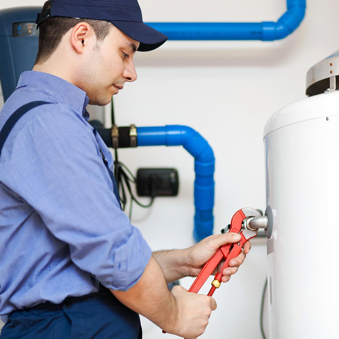 plumber fixing a water heater pipe