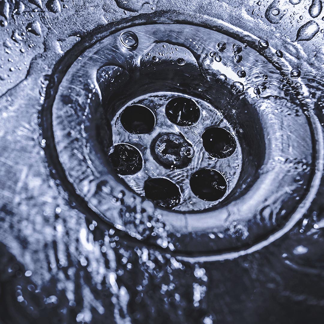 drain with water going down it