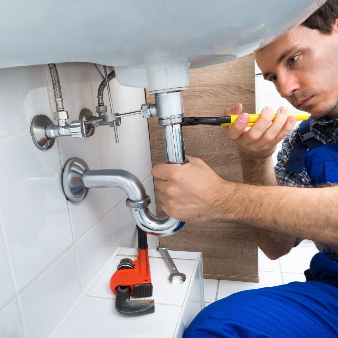 a plumber working under a sink