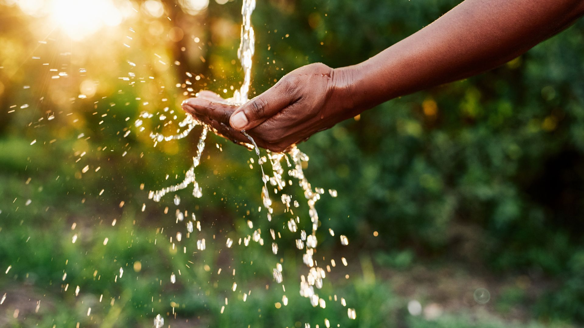 water running over hand outside