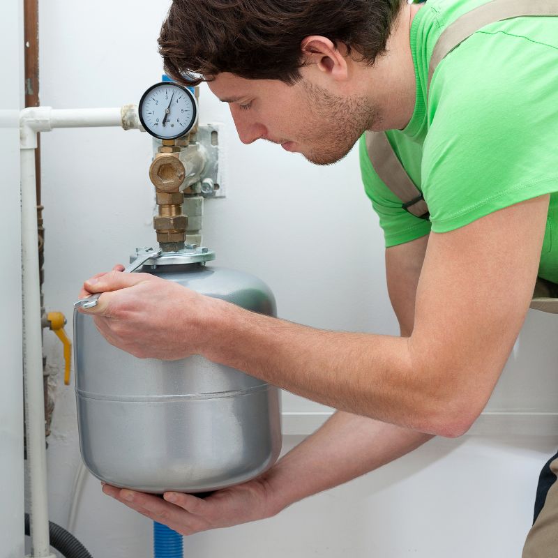a man installing a small boiler