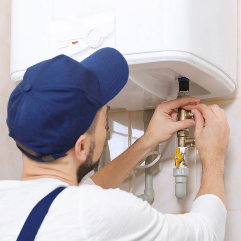 a man adjusting tubes on a tankless water heater