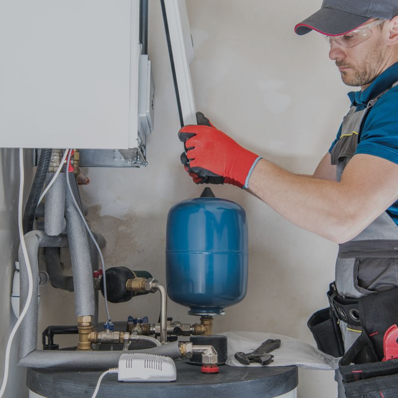 Plumber performing water heater repair