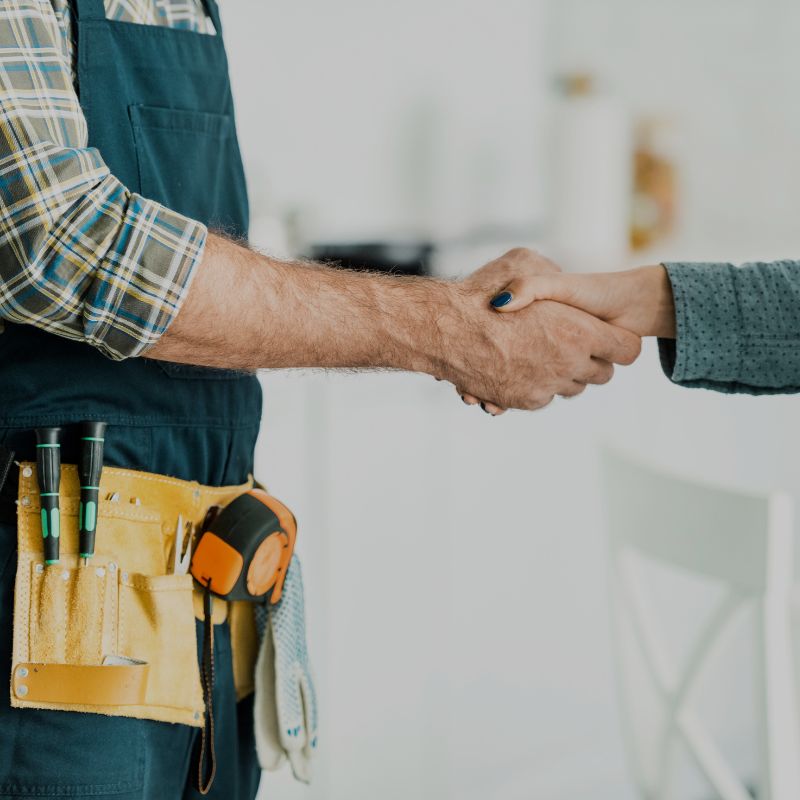 A plumber shaking hands with a customer