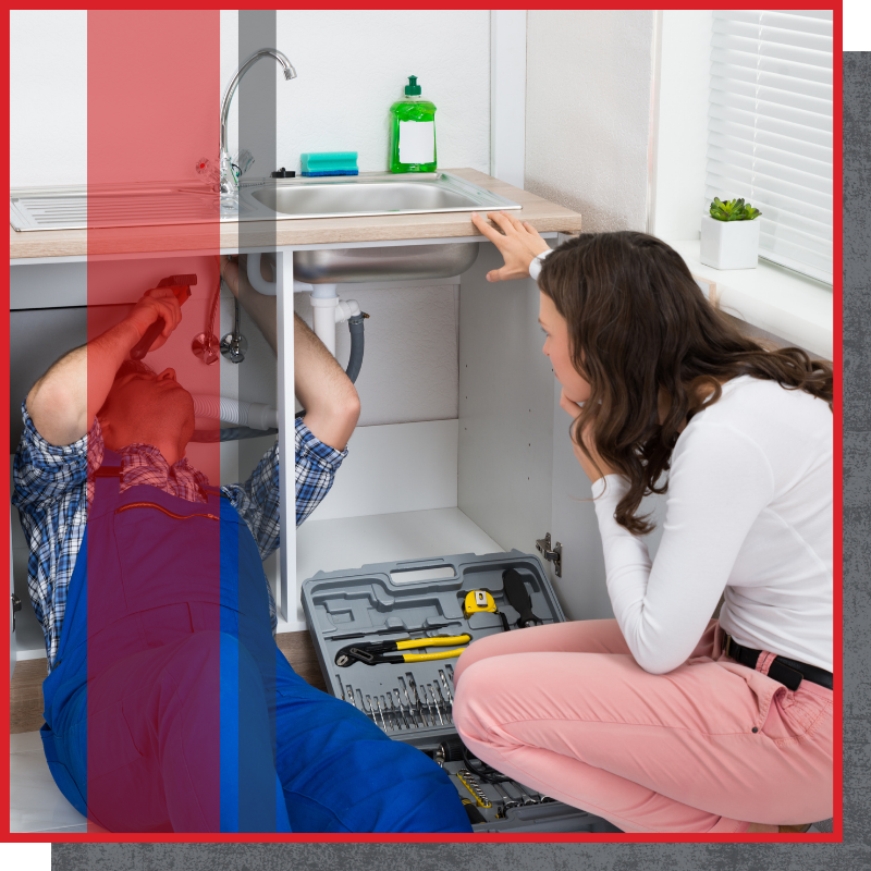 plumber working under a sink