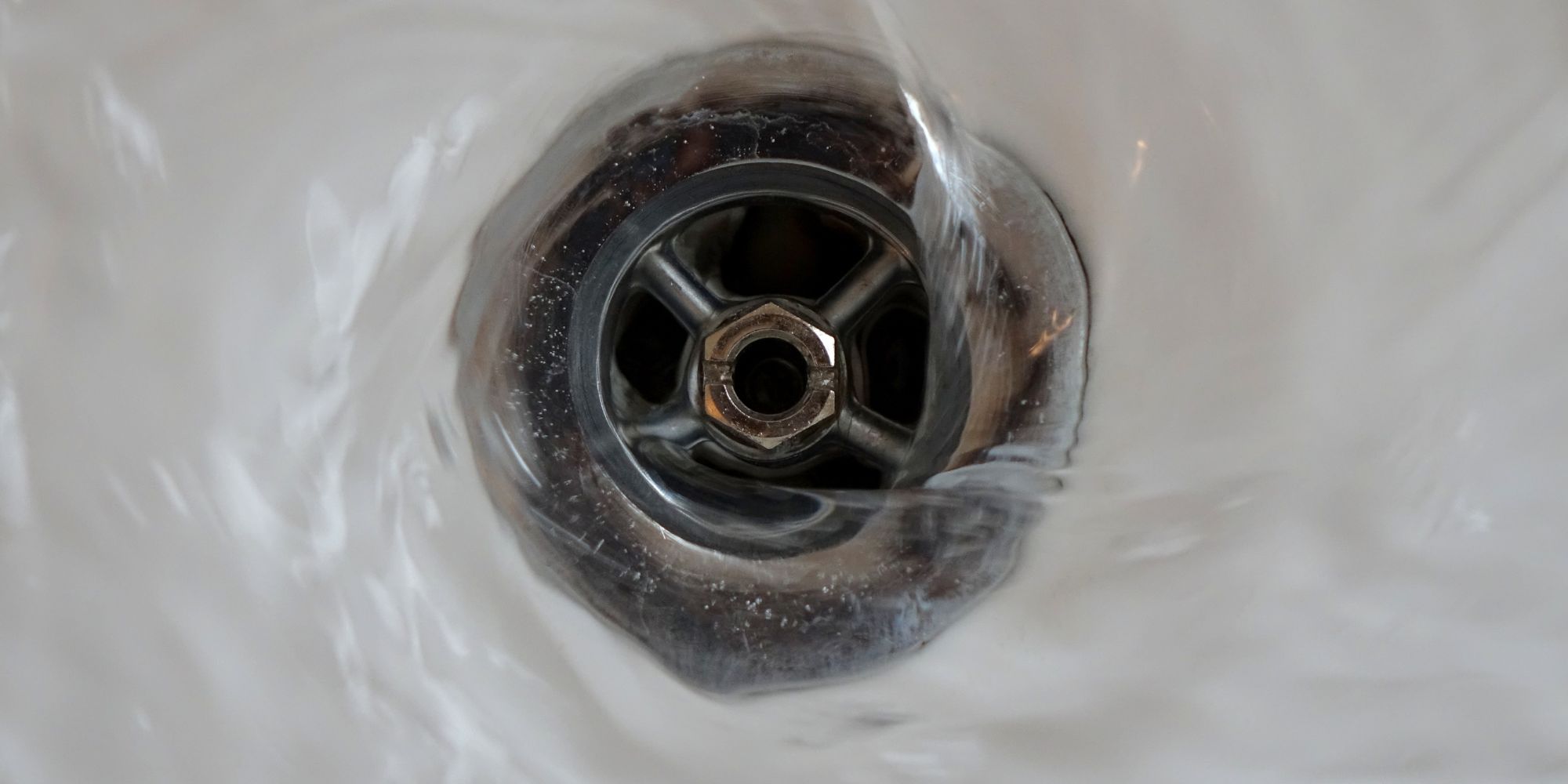 Water flowing smoothly down a drain