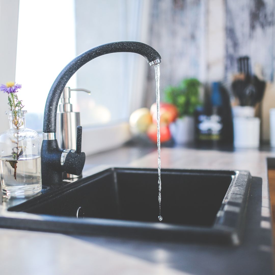 Water flowing from a nice, modern kitchen sink