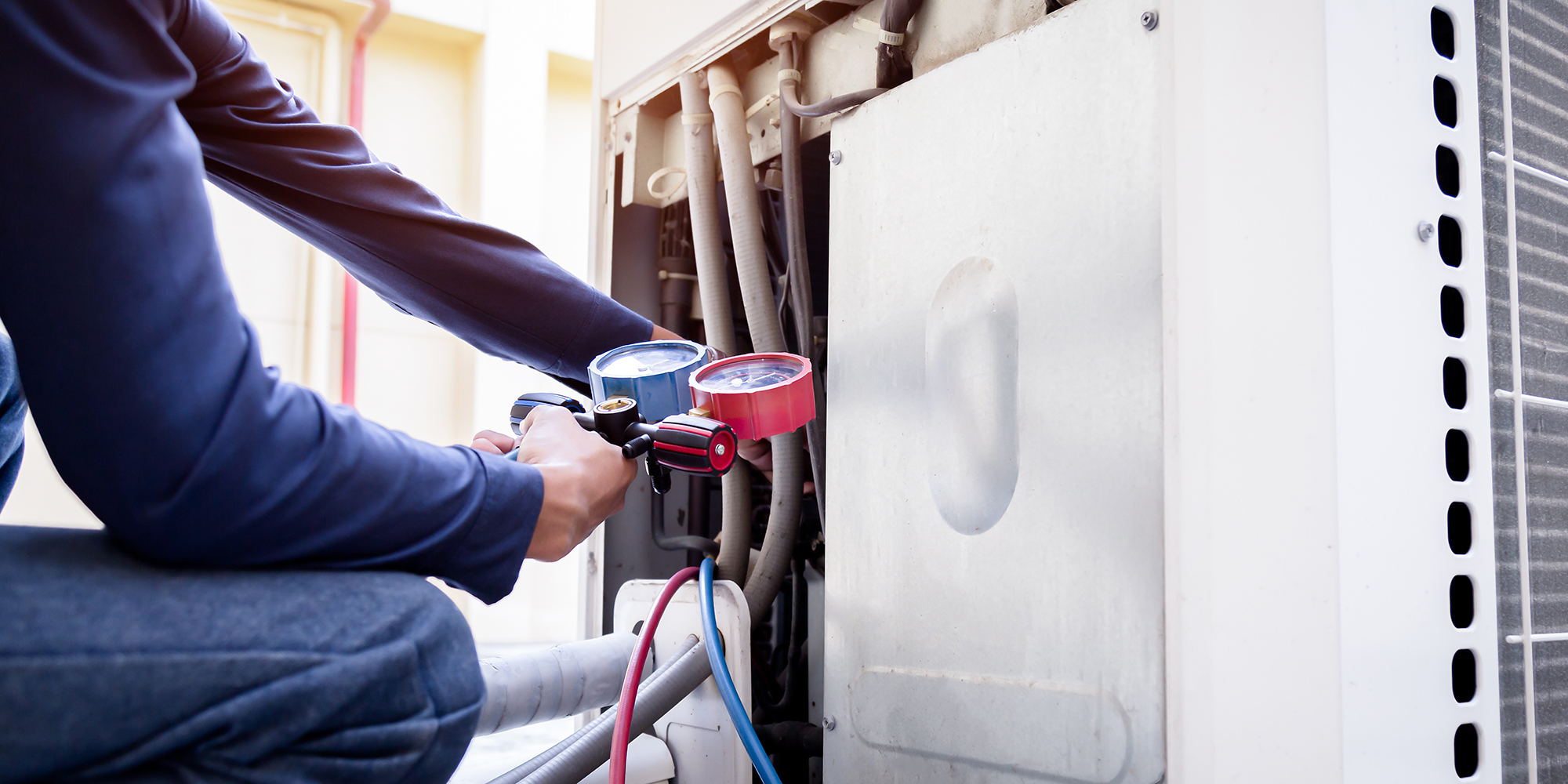 Technician is checking air conditioner ,measuring equipment for filling air conditioners.